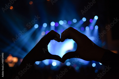 Heart-shaped hand at concert