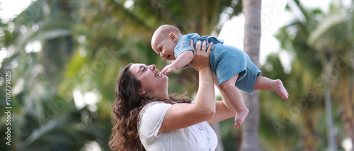  Mother and her baby son playing on the beach during summer vacation