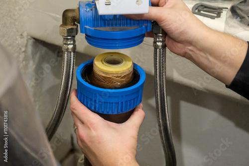 Replacement of a water softener filter cartridge by a technician, in a house.