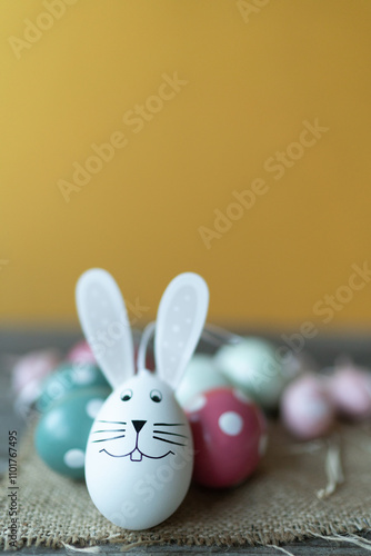 Easter bunny in front of Easter eggs