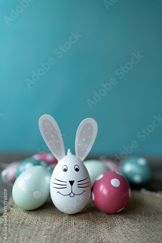 Easter bunny in front of Easter eggs