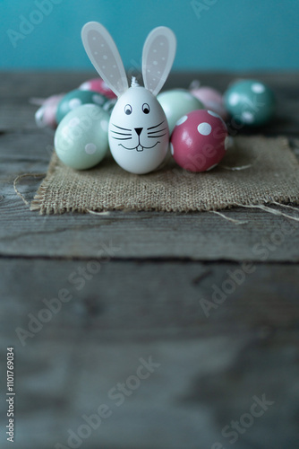 Easter bunny in front of Easter eggs