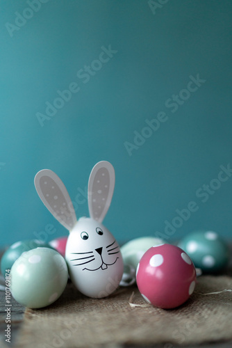 Easter bunny in front of Easter eggs