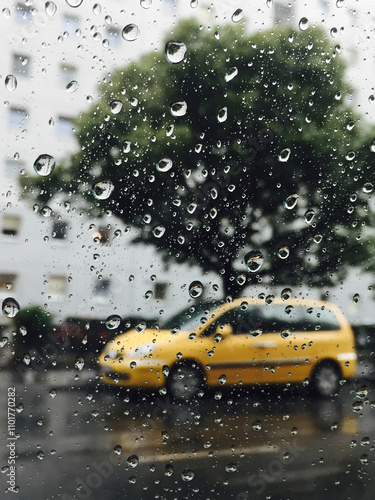 A yellow car photographed through the glass window while driving