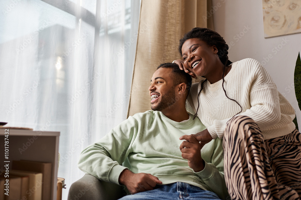 A couple enjoys quality time together at home while wearing warm sweaters during winter. A couple enjoys quality time together at home while wearing warm sweaters during winter.