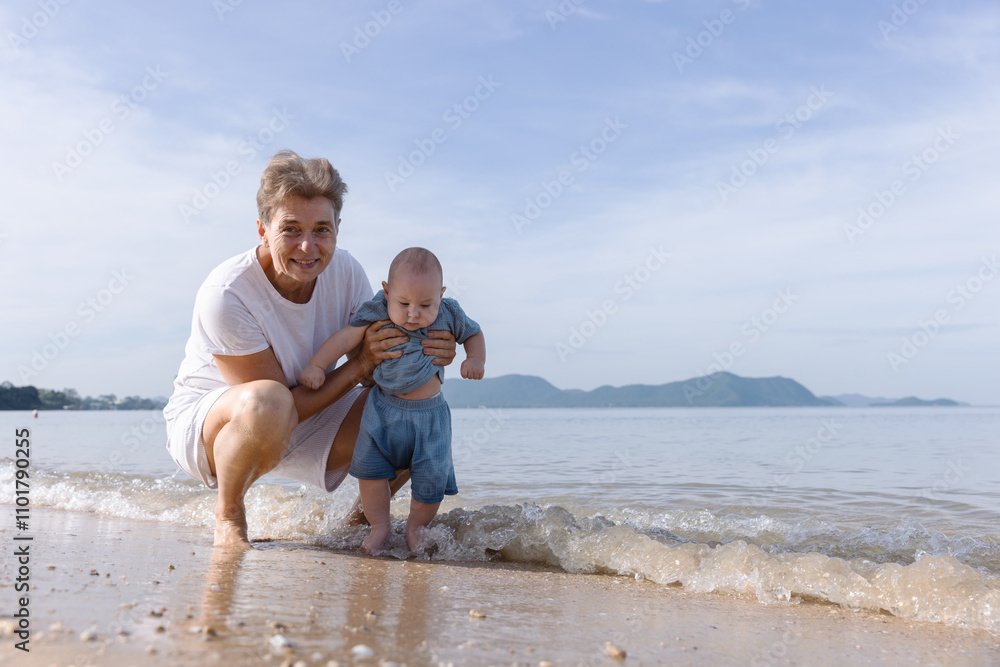 Grandmother Enjoying Quality Time with Baby at the Beach, Exploring the Waves, Sand, and Scenic Ocean View Together on a Beautiful Sunny Day, Creating Cherished Family Memories by the Shoreline Grandmother Enjoying Quality Time with Baby at the Beach, Exploring the Waves, Sand, and Scenic Ocean View Together on a Beautiful Sunny Day, Creating Cherished Family Memories by the Shoreline