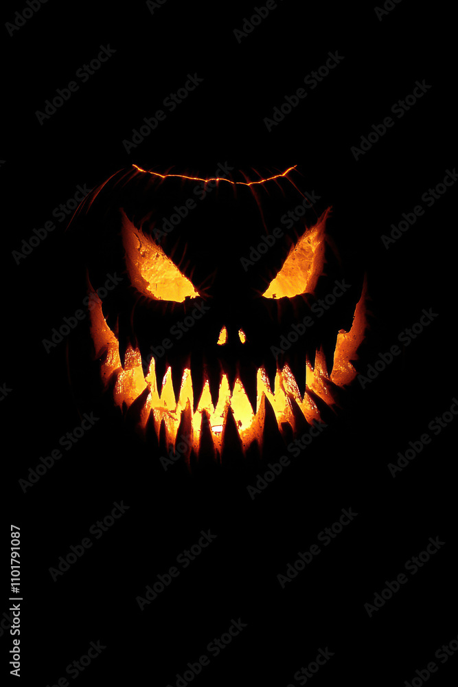 Fototapeta premium Halloween pumpkin with fangs on black background