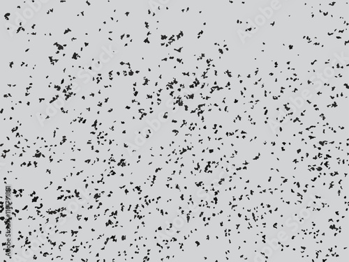 Scattered ash particle vector illustration. Monochrome grunge texture with random black specks on gray background. Mottled pattern with random spots