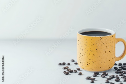Warm cup of coffee beside scattered coffee beans on a simple white background