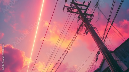 A close-up bottom view of overhead power lines against a sunset sky in Jakarta, Indonesia, with digital laser beams. Industrial technology background.