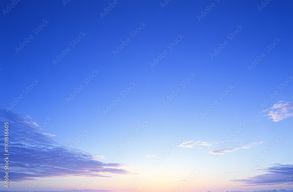 Obraz premium Wispy clouds enhance the beauty of the sunrise against a blue expanse.