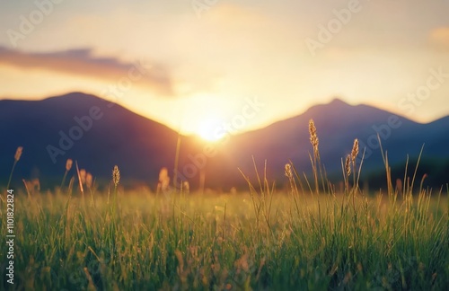 Majestic mountain landscape at sunset with green fields and rolling hills in ...