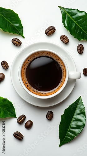 Freshly brewed coffee with coffee beans and green leaves arranged around a wh...