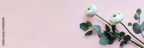 Beautiful arrangement of white flowers and greenery on a soft pastel backgrou...