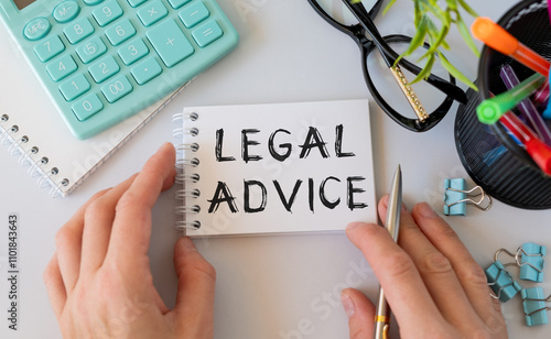 LEGAL ADVICE text on a paper clipboard with chart and notebook on withe background