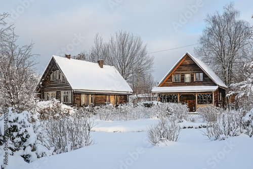 Snow covered village house, outside of a wooden cozy home with snow falling in the winter season December. AI generated