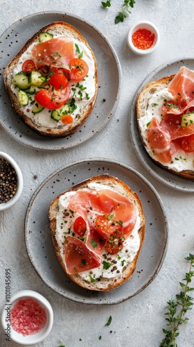 Delicious open faced sandwiches topped with fresh vegetables and cured meat o...