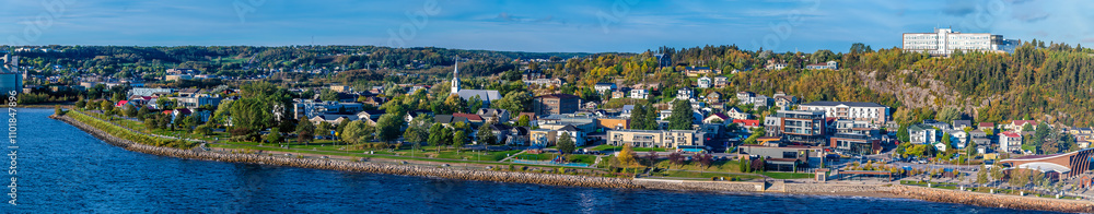 Fototapeta premium A panorama view along the shoreline from the cruise terminal in the bay at Saguenay, Quebec in Canada in the fall