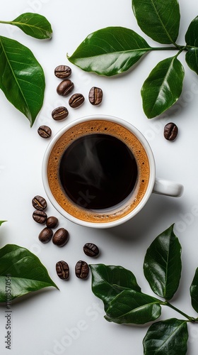 Freshly brewed coffee with coffee beans and green leaves arranged around a wh...