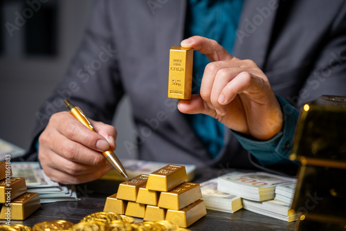 Gold bar stock photo, picture and photo on black table at night.