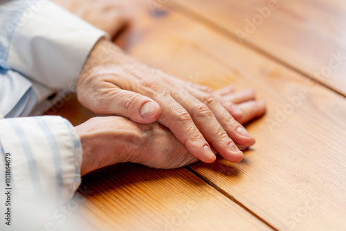 hands close up elderly people sitting at the table woman hugging her husband happy old age elderly couple pleasant memories leisure time in old age warm feelings support in old age difficult times