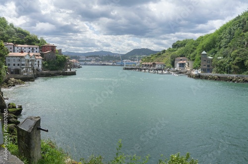 Views of the Cantabrian Sea towards the fishing port of Pasaia on a bright and sunny day.