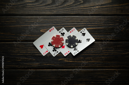 Playing cards and winning black and red chips on a vintage casino table. Concept of a successful combination of two pairs for a good win in poker photo