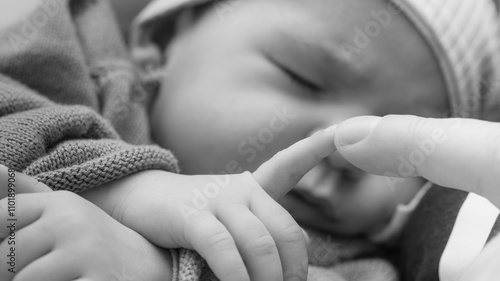 newborn finger touching hand mother photo