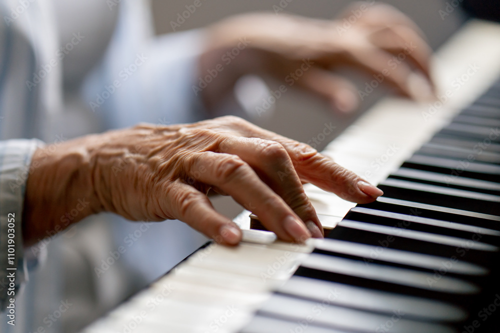 Fototapeta premium hands close up an elderly woman sits at the piano playing a melody learning new chords old age memories of an elderly couple pleasant leisure time in old age warm feelings support in old age