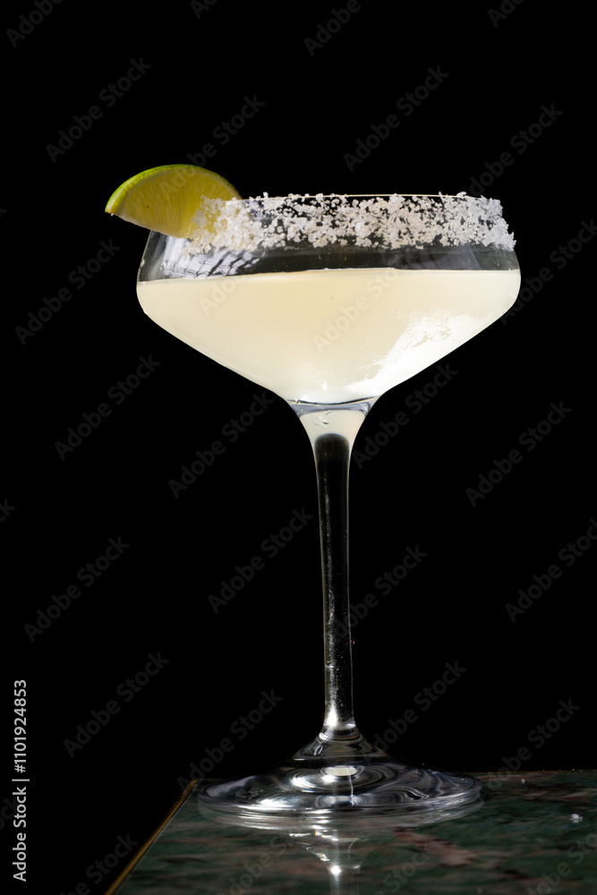 Cocktail with salt on the glass and lime.
Cocktail with salt on the glass and lime.