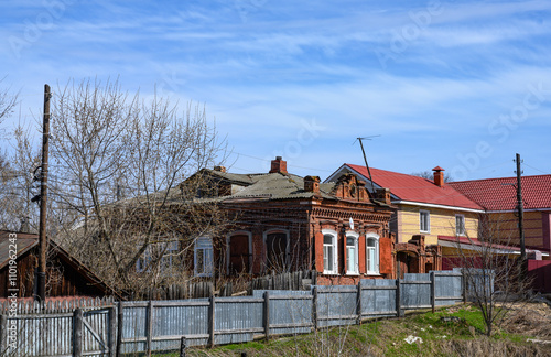 A street with brick houses and a wooden fence in Gorodets, Russia photo