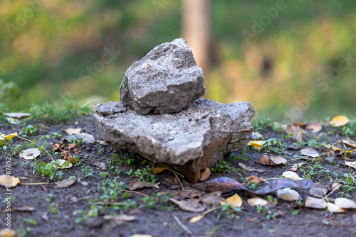 A stone on the ground and a smaller stone on it