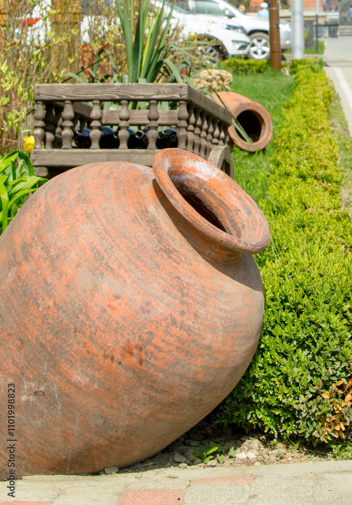 large clay jug on a green grass large clay jug on a green grass