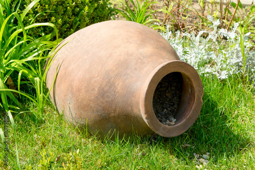 large clay jug on a green grass