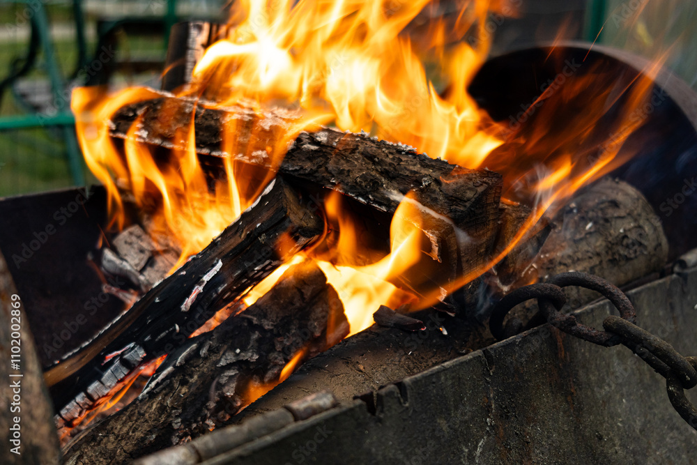 Fire and Flame. Burning charcoal barbecue grill. Bright flame and fire from burning woods Fire and Flame. Burning charcoal barbecue grill. Bright flame and fire from burning woods