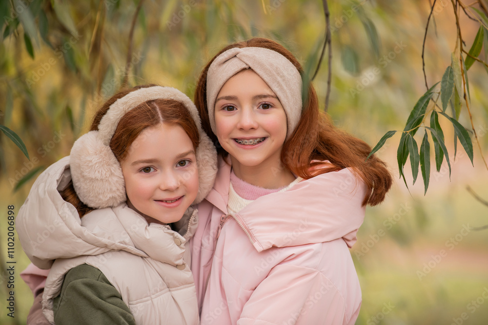 Close-up portrait of two red-haired teenage sisters in autumn park. Close-up portrait of two red-haired teenage sisters in autumn park.