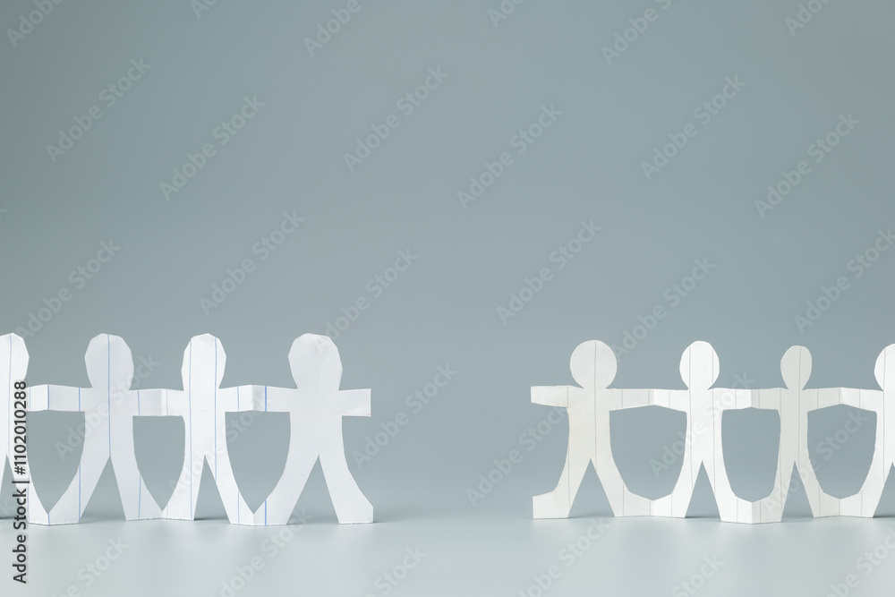 Two paper teams with a gap, missing role to connect, or two teams close to working together, and collaboration concept Two paper teams with a gap, missing role to connect, or two teams close to working together, and collaboration concept