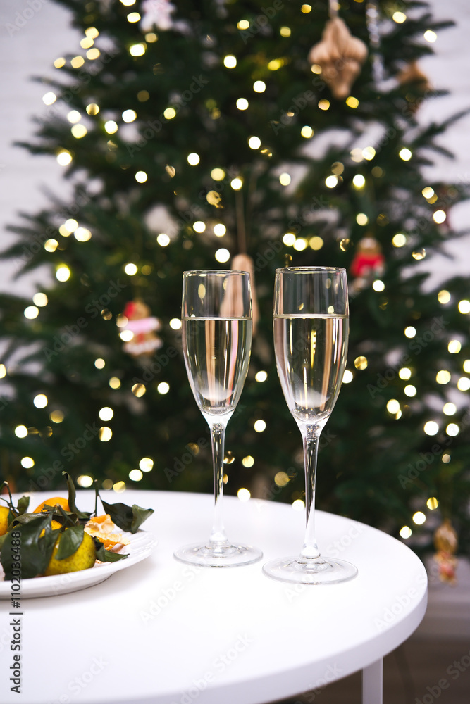An Elegant Holiday Toast with Sparkling Champagne Enjoyed Near a Beautiful Christmas Tree An Elegant Holiday Toast with Sparkling Champagne Enjoyed Near a Beautiful Christmas Tree