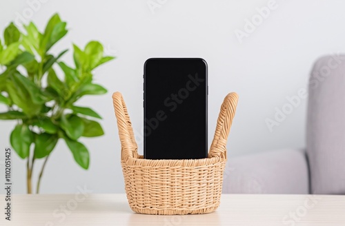 The smartphone is placed in a separate wicker box on the table. They avoid using digital gadgets at home, preferring face-to-face interactions with family, highlighting the concept of digital detox