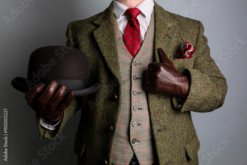 Gentleman in Tweed Suit and Leather Gloves Holding Bowler Hat. Vintage Style of Classic English Country Gentleman.