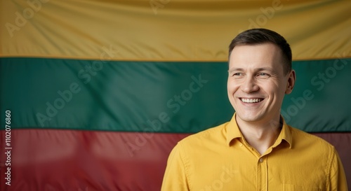 Joyful man in yellow shirt smiling against lithuanian flag background for cultural imagery and national pride themes photo