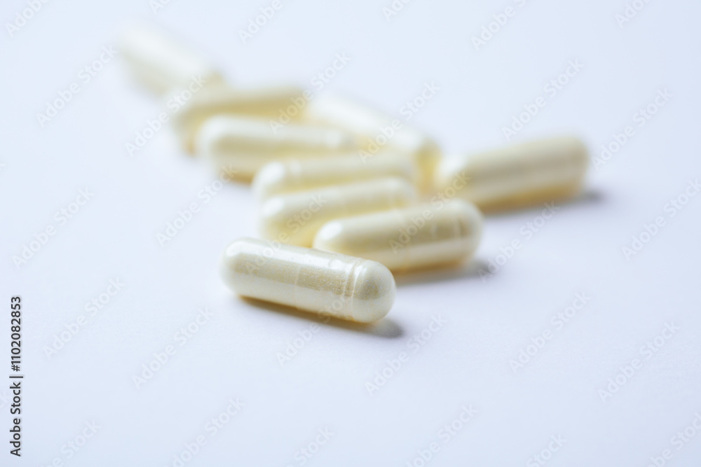 Alpha-lipoic acid capsules. Paper background. Soft focus. Close up. Copy space. Alpha-lipoic acid capsules. Paper background. Soft focus. Close up. Copy space.