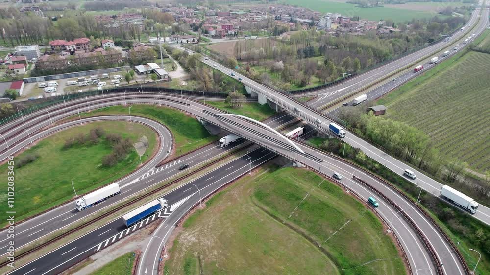 The European highways and road infrastructure, captured with drone footage showcasing the flow of traffic from above. The European highways and road infrastructure, captured with drone footage showcasing the flow of traffic from above.