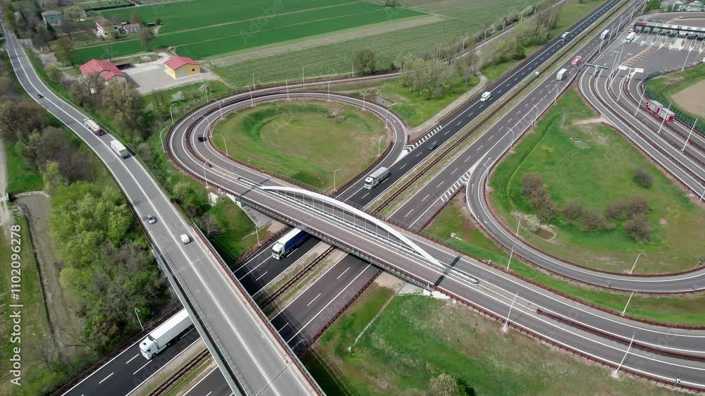 The European highways and road infrastructure, captured with drone footage showcasing the flow of traffic from above. The European highways and road infrastructure, captured with drone footage showcasing the flow of traffic from above.