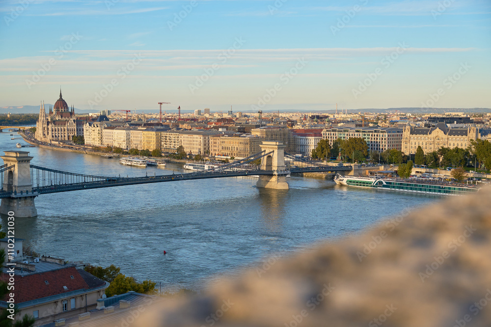 A stunning daytime view of Budapest from above, with the iconic Fisherman's Bastion and the Parliament Building framing the city’s dynamic skyline A stunning daytime view of Budapest from above, with the iconic Fisherman's Bastion and the Parliament Building framing the city’s dynamic skyline