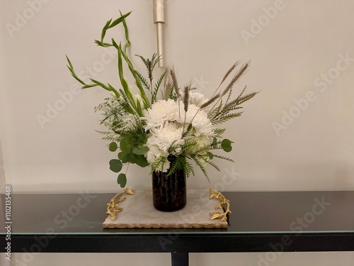 A flower arrangement on a table in the entrance at the Waldorf Astoria Hotel in Atlanta, GA photo