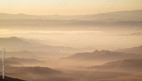 Misty mountain landscape at sunrise.