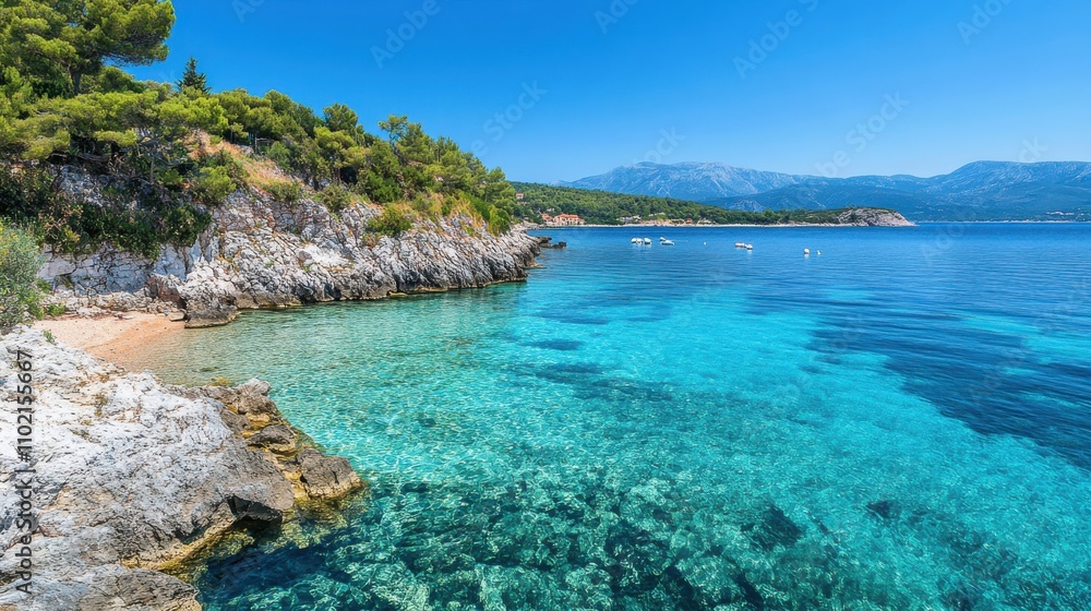 Fototapeta premium Crystal clear waters and rocky shoreline at a tranquil beach in Greece on a sunny day