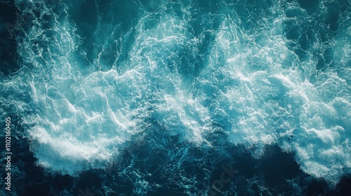 Waves crashing against the shore at sunrise with vibrant blue and white colors in the ocean