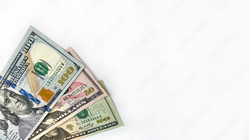 Close-up of US dollar bills including 20, 50, and 100 denominations, arranged neatly on a clean white background with ample copy space. Ideal for financial themes, investment ads, or banking promotion Close-up of US dollar bills including 20, 50, and 100 denominations, arranged neatly on a clean white background with ample copy space. Ideal for financial themes, investment ads, or banking promotion